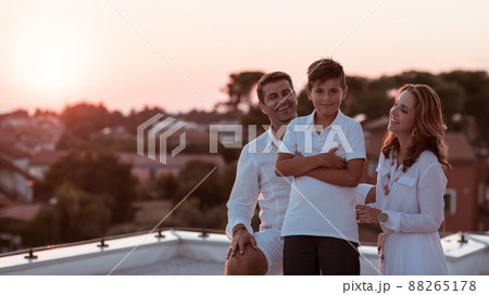 Happy family enjoys and spends time together on the roof of the house. Selective focus Happy family enjoys and spends time together on the roof of the house. Selective focus 88265178