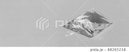 Crystal prism with light diffraction of spectrum colours and reflection with trendy light and hard shadows on a white background. Light spectrum reflected through glass prism 88265238