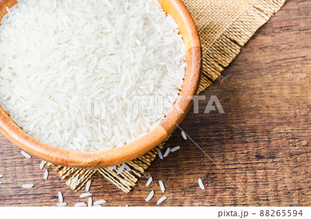 Rice in a bowl on wooden table 88265594