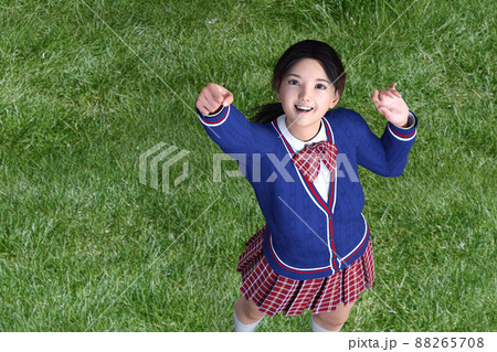 校庭の芝生の上に立ち、勢いよく手を上にあげる女子高生。3Dイラスト 3Dレンダリング 88265708