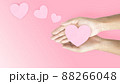 the hand holding a heart shaped paper 88266048