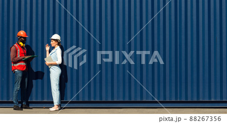 Businesswoman and engineer talking and checking loading Containers box from Cargo freight ship for import export. shipping in docks. Businesswoman and engineer talking and checking loading Containers box from Cargo freight ship for import export. shipping in docks. 88267356