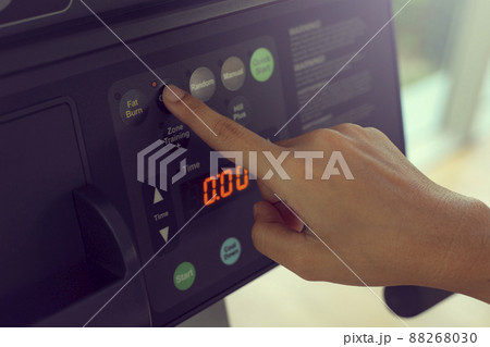 Close up hand women training on treadmill, doing cardio workout in gym. Close up hand women training on treadmill, doing cardio workout in gym. 88268030