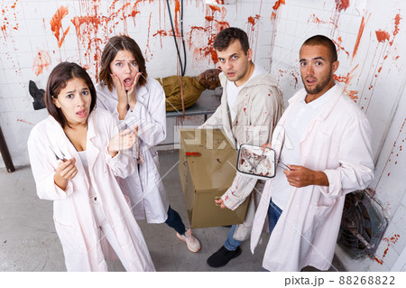 Young people in lost room with bloody walls Young people in lost room with bloody walls 88268822