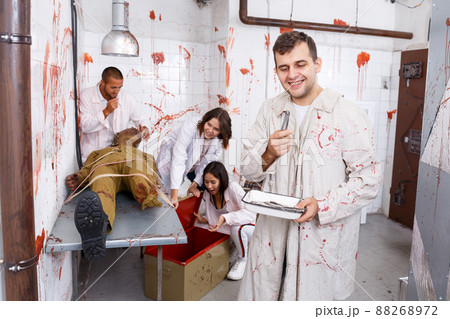 Cheerful guy in quest room with bloody traces Cheerful guy in quest room with bloody traces 88268972