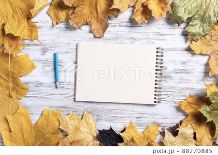 Spiral sketchbook and pen on wooden desk 88270885