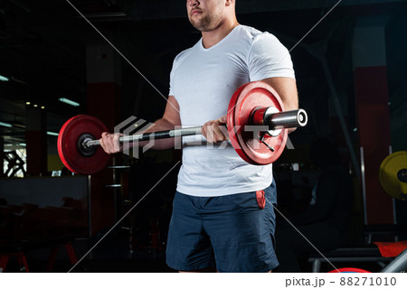 Male athlete lifts the barbell Male athlete lifts the barbell 88271010