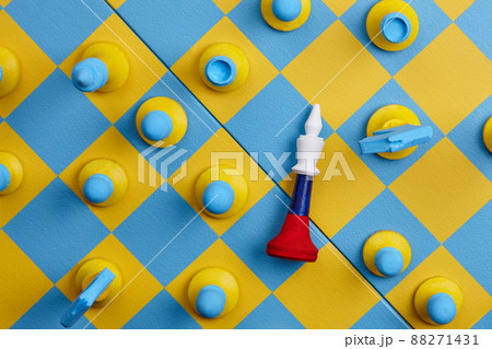 Ukrainian and Russian national colors chess sets on blue and yellow board 88271431