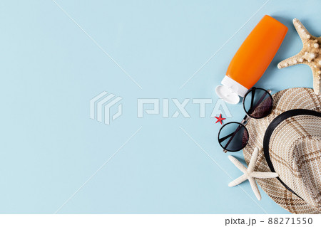 Beach accessories on pastel blue background top view. Summer background. 88271550