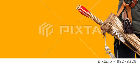 Archer with Vintage Quiver and Wooden Arrows Isolated on Orange Background 88273329