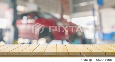 Empty wood table top with car service centre auto repair workshop blurred background Empty wood table top with car service centre auto repair workshop blurred background 88273406