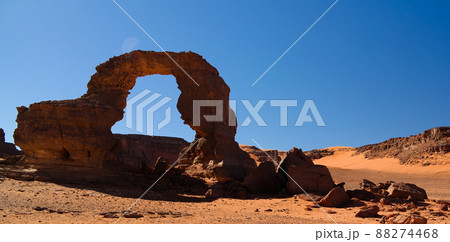 Arch Rock formation aka Arch of Africa or Arch of Algeria with moon at Tamezguida in Tassili nAjjer national park in Algeria 88274468