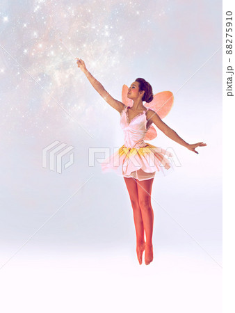 Bringing the magic. A full length shot of a cute fairy casting a spell. 88275910