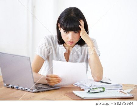 Ive gone way over budget. A shocked businesswoman reading the financial breakdown of her budget. 88275934