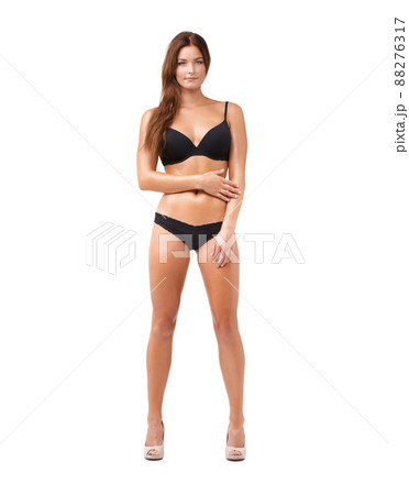Her confidence is sexy. Full length shot of an attractive young woman posing in lingerie against white background. Her confidence is sexy. Full length shot of an attractive young woman posing in lingerie against white background. 88276317