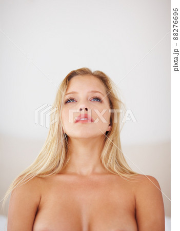 Contemplating the essence of beauty. A beautiful blonde woman posing topless. Contemplating the essence of beauty. A beautiful blonde woman posing topless. 88276696