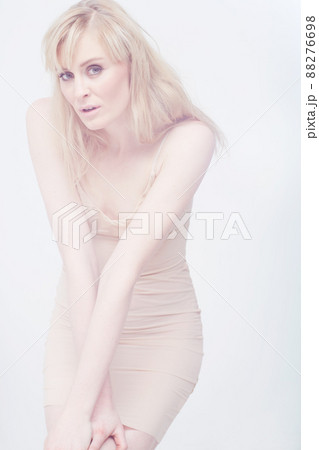 Timeless beauty. Insecure young woman standing isolated against a white background. Timeless beauty. Insecure young woman standing isolated against a white background. 88276698