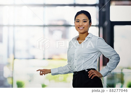 I was built for the business world. Portrait of a young businesswoman standing with her hand on her hip in the office. I was built for the business world. Portrait of a young businesswoman standing with her hand on her hip in the office. 88277046