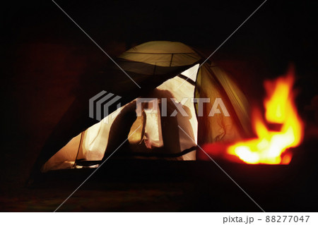Tender moments while camping. Silhouette view of a young couple kissing in a tent. Tender moments while camping. Silhouette view of a young couple kissing in a tent. 88277047