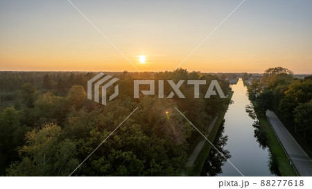Beautiful sunset over a river with green bushes and color rich sky 88277618