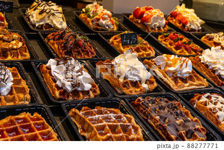 Belgian waffles with colorful toppings on showcase. Brussels 88277771