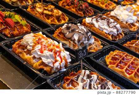 Belgian waffles with colorful toppings on showcase. Brussels 88277790