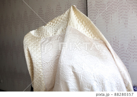 Muslim woman housewife lays a bedspread on the bed 88280357