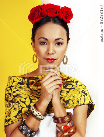 young pretty mexican woman smiling happy on yellow background, lifestyle people concept 88283137