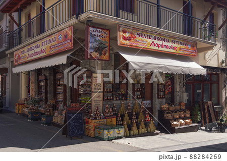Outdoor showcase day view of local honey products Greek shop with sign. Outdoor showcase day view of local honey products Greek shop with sign. 88284269