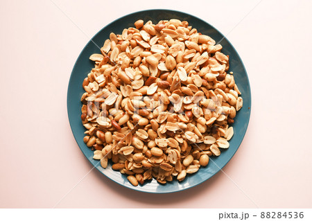 Processed pea nuts in a bowl on table top down . 88284536