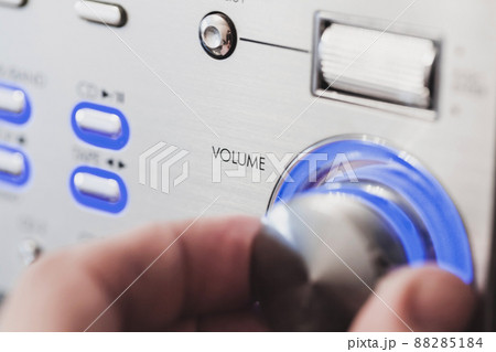 Male hand is on a volume control knob, close up-photo Male hand is on a volume control knob, close up-photo 88285184