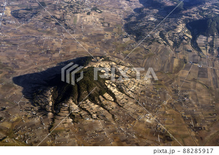 Mexico guadalajara fields and volcanos aerial view panorama landscape from airplane while flying from mexico city Mexico guadalajara fields and volcanos aerial view panorama landscape from airplane while flying from mexico city 88285917