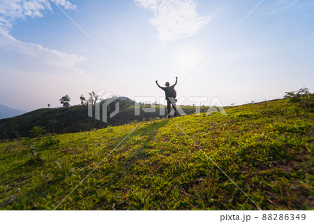 solo backpacker man happy and joyful after success climb the mountain 88286349