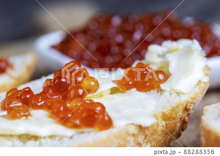 red salmon or trout caviar with white baguette and butter 88288356
