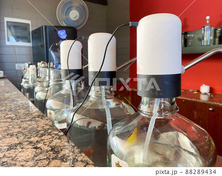 Various alcohol bottles in a bar or restaurant. 88289434