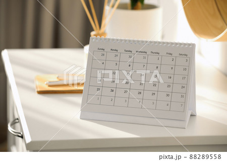 Paper calendar on white chest of drawers indoors 88289558