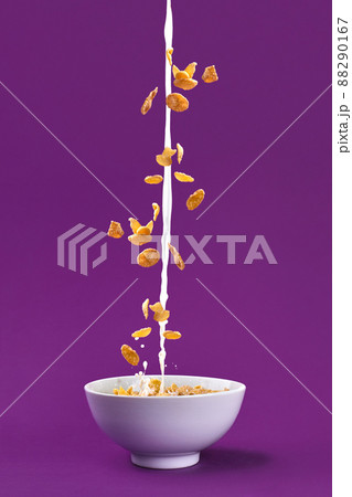 Falling granola with milk splash in bowl. Healthy breakfast ingredients. Flying food 88290167