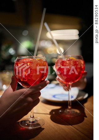 Italian cocktail with orange slices on gray stone table. Summer drink, homemade. 88290534