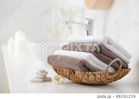 Basket with clean towels on counter in bathroom 88291259