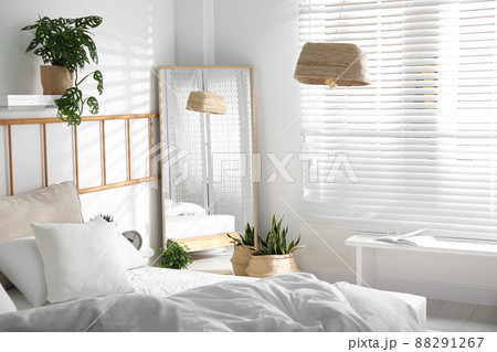Modern bedroom interior with stylish large mirror 88291267