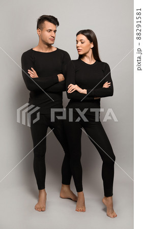 Couple wearing thermal underwear on grey background 88291581