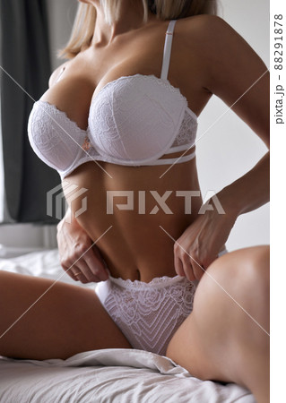 Young woman on her bed wearing white underwear. Young woman on her bed wearing white underwear. 88291878