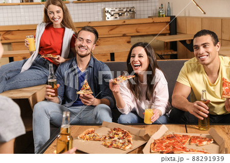 Group of friends having fun party with delicious pizza in cafe 88291939
