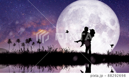 Silhouette at night landscape of couple or lover dancing and singing on the mountain with Milky way background over the full moon. 88292698