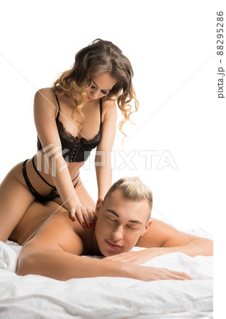 Sensual woman sitting on shirtless man during foreplay 88295286