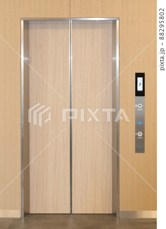 Wooden elevator door, in a shiny, polished, metal frame, Wooden elevator door, in a shiny, polished, metal frame, 88295802