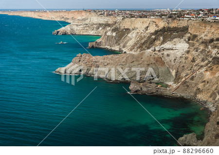 View of Crimean rugged rocky with Diana's Grotto and beach from top of the cliff on Fiolent Cape. Sevastopol. Crimea View of Crimean rugged rocky with Diana's Grotto and beach from top of the cliff on Fiolent Cape. Sevastopol. Crimea 88296660