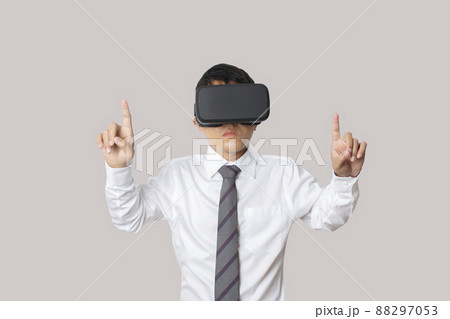 Studio portrait man wearing VR Headset isolated on gray background. 88297053