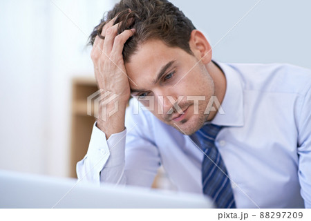 When work just becomes too much.... A young businessman looking frustrated at the office. 88297209