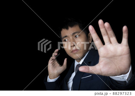 Portrait of businessman using smartphone show stop gesture sign by hand. Portrait of businessman using smartphone show stop gesture sign by hand. 88297323
